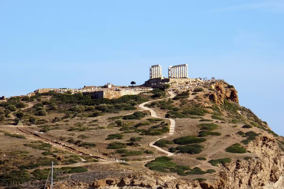 Temple of Poseidon atop Cape Sounio cliff, scenic stop on private Athens Riviera day tour from Athens