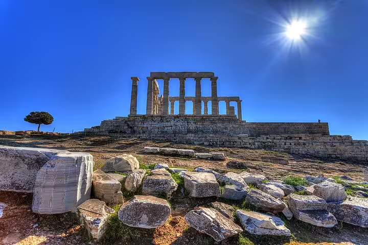 Temple of Poseidon ruins at Cape Sounio under bright sun, Athenian Riviera private tour from Athens
