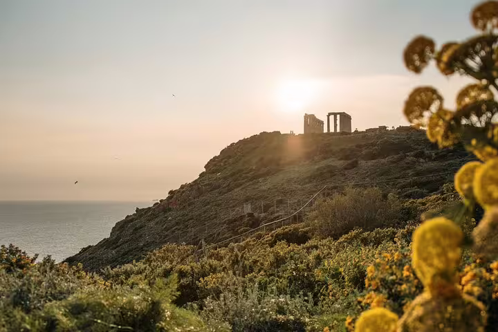 Sunset view of the Temple of Poseidon at Cape Sounion above the Aegean Sea on a half-day tour from Athens