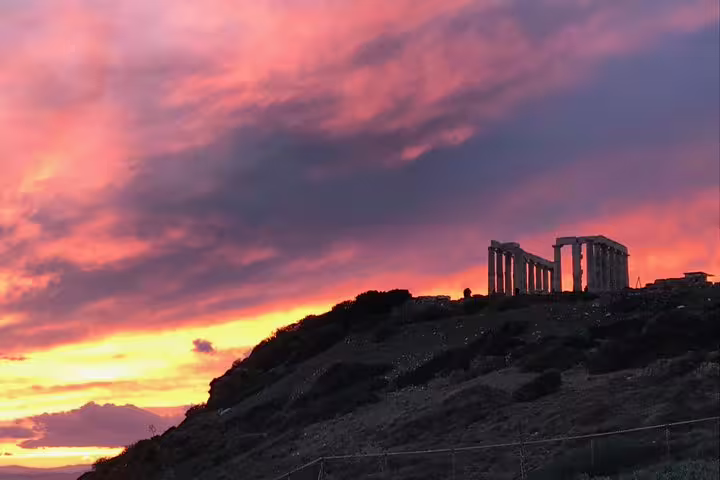 Temple of Poseidon at Cape Sounion glowing at sunset on a half-day small-group tour from Athens