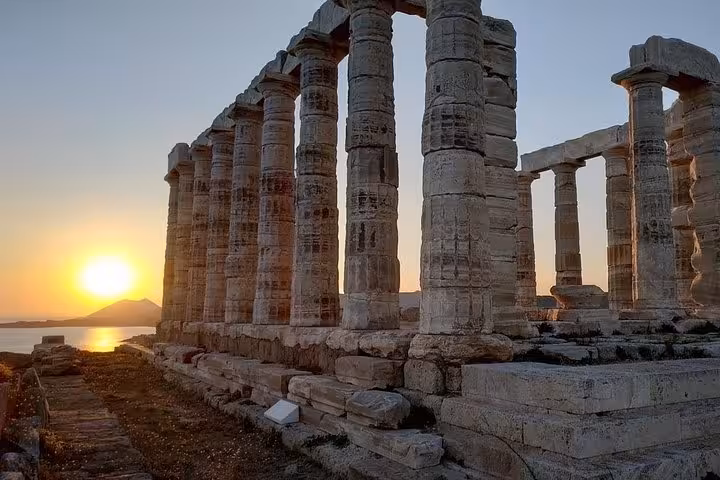 Ancient Temple of Poseidon columns at Sounion at dusk, highlight of a luxury private sunset tour from Athens
