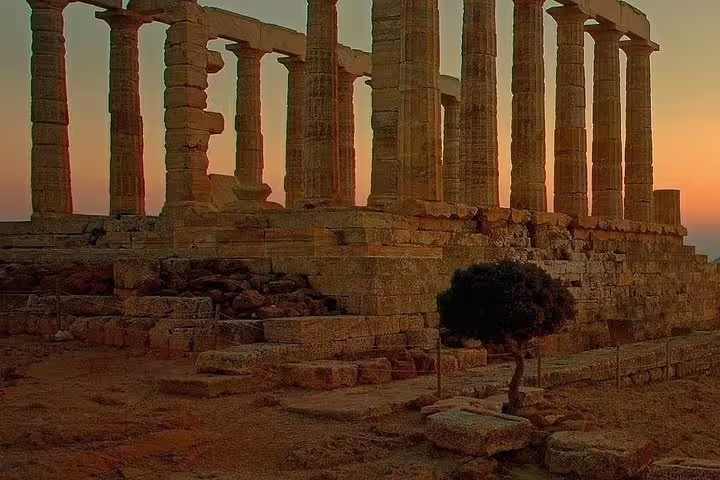 Temple of Poseidon columns glowing at golden hour in Cape Sounion, Greece, on a private sunset tour from Athens
