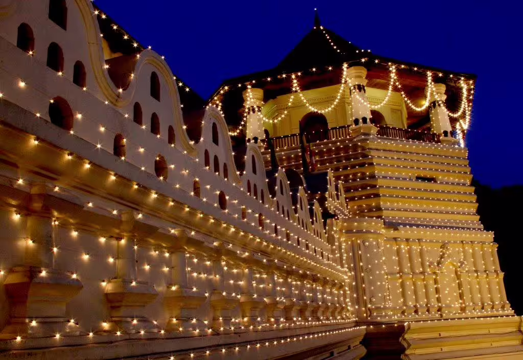 Temple of the Tooth in Kandy, Sri Lanka, beautifully illuminated at night, a must-see on the private tour.