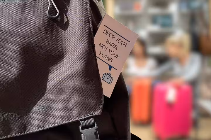 Backpack with “Drop your bags, not your plans” tag promoting secure luggage storage in Tenerife