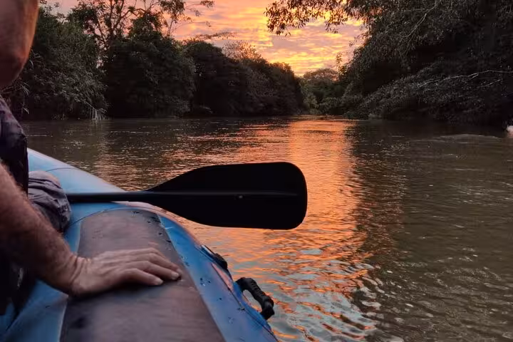 Scenic sunset view from a Tenorio wildlife safari boat tour, ideal for bird watching and nature photography.