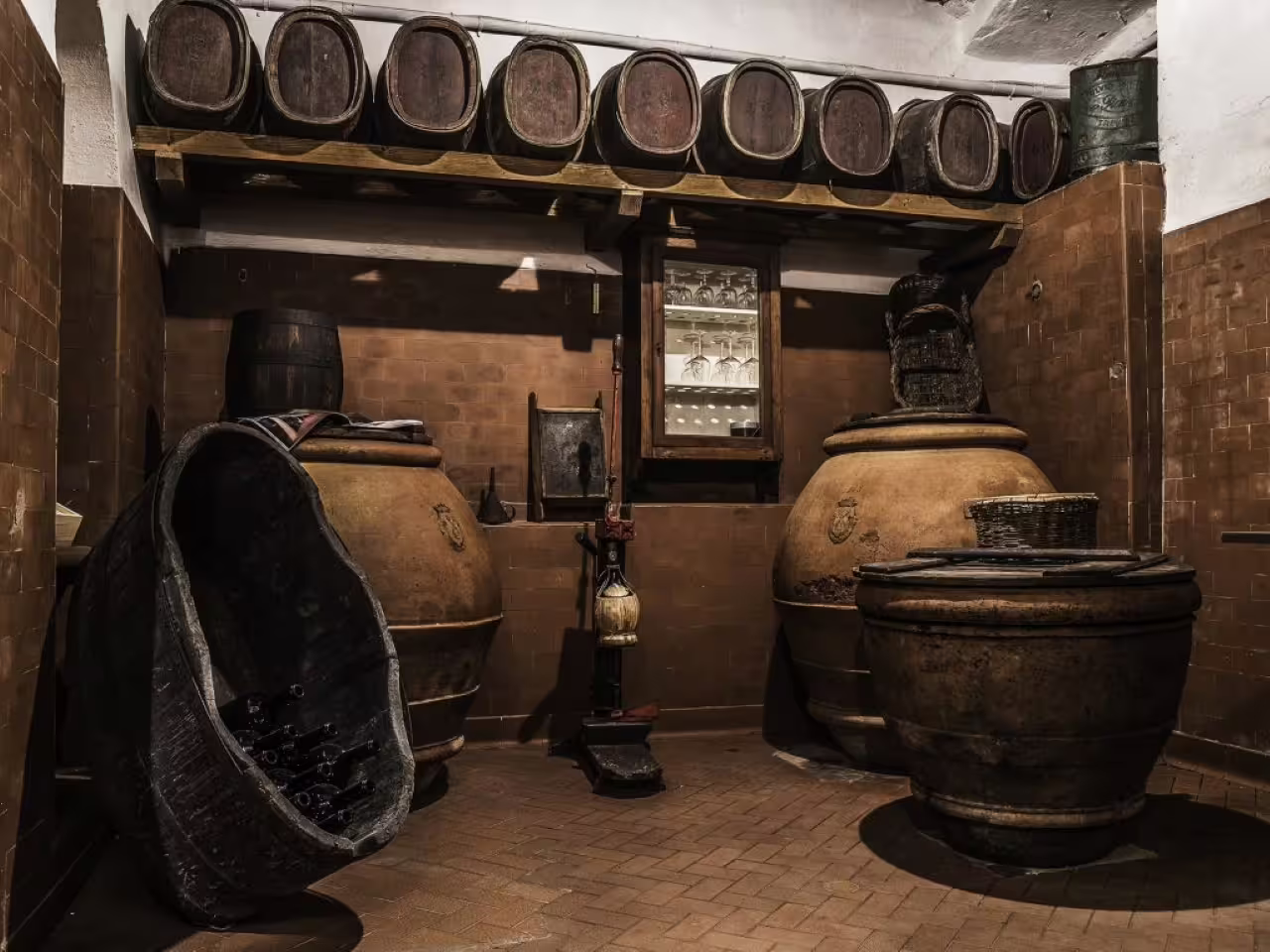 Historic Tenuta Bossi cellar with terracotta vats and barrels, part of the Explore Elegance 3-wine tasting experience