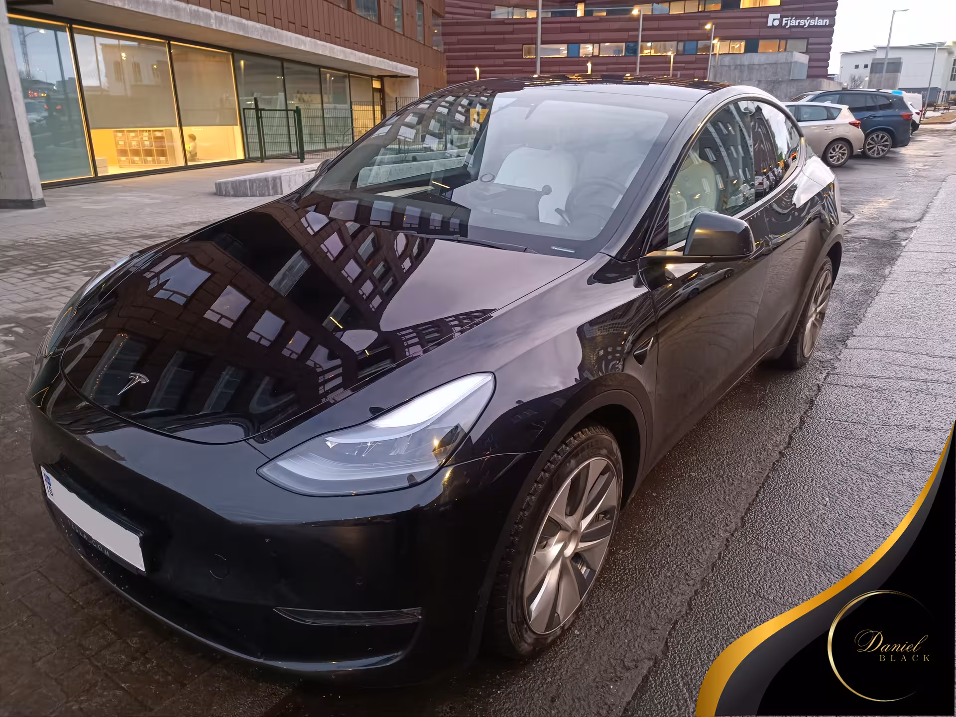 Black Tesla ready for private KEF International Airport to Reykjavík transfer, parked downtown Reykjavík