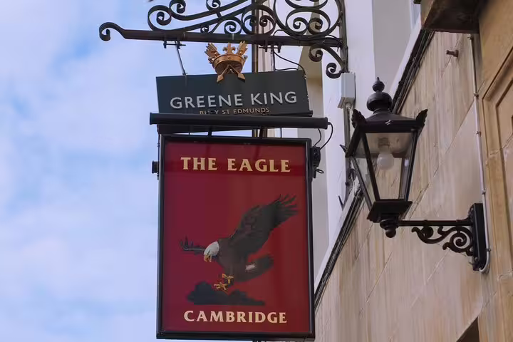 The Eagle pub sign in Cambridge, a Greene King establishment featuring a bald eagle on red background