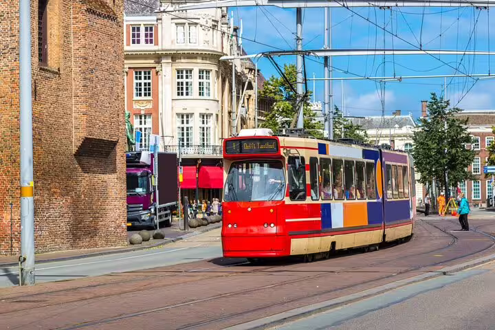 Colorful tram passing through The Hague old town historic city center on a sunny day