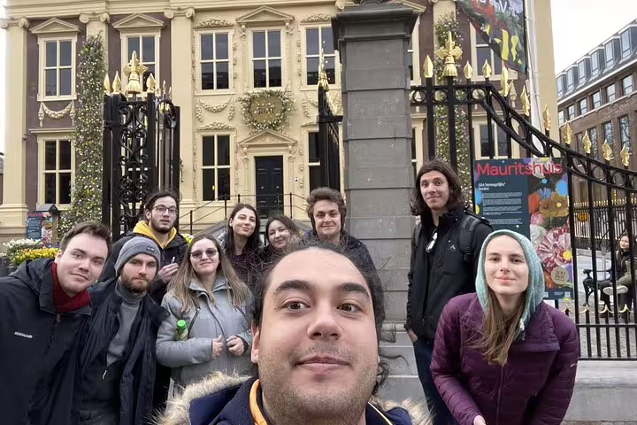 Group of tourists taking a selfie in front of the Mauritshuis museum in The Hague old town
