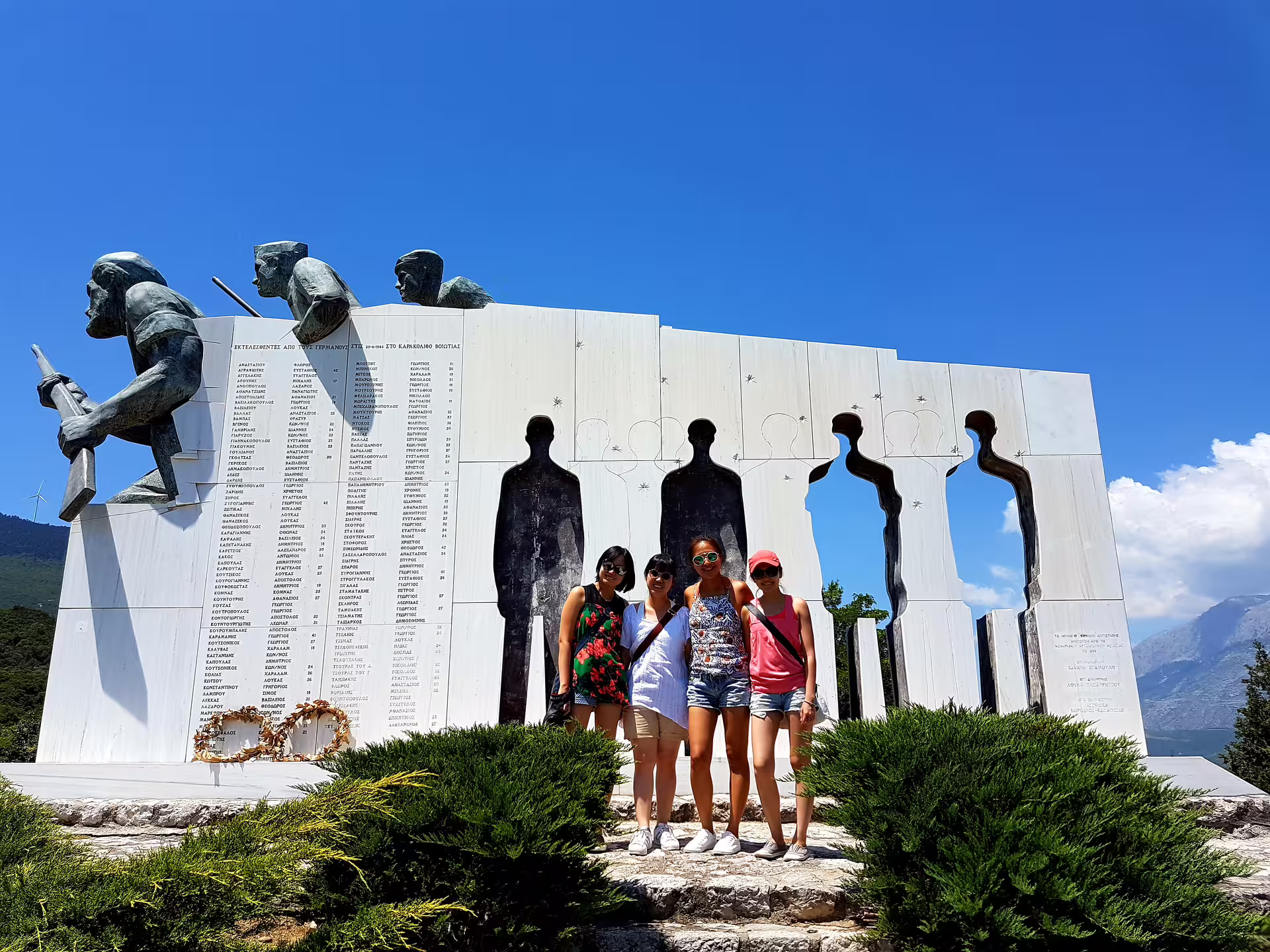Visitors at Thermopylae memorial monument on private 2-day Delphi Meteora tour from Athens with overnight stay