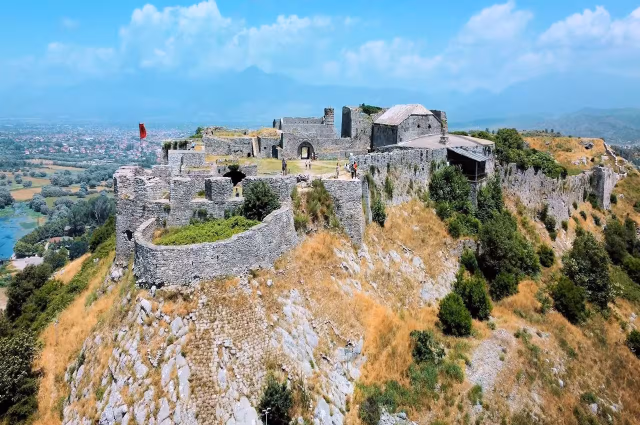 Aerial view of Valbone's ancient fortress set against a lush landscape, a highlight of Theth – Valbone Tour.