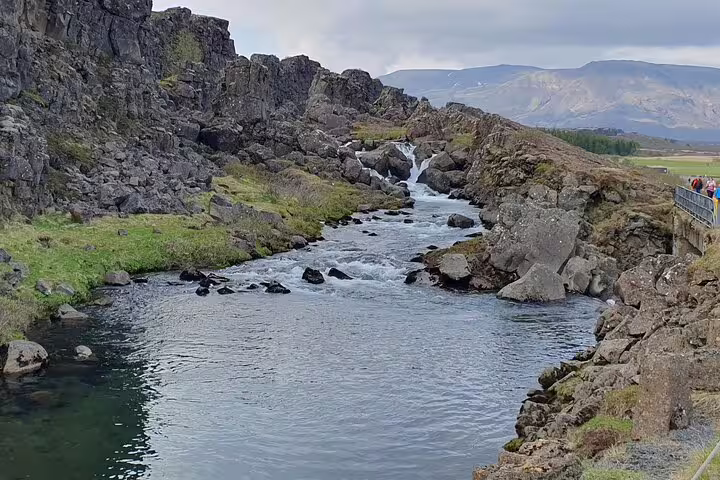 Rocky canyon with clear river flowing through Þingvellir, Iceland, on Golden Circle tour