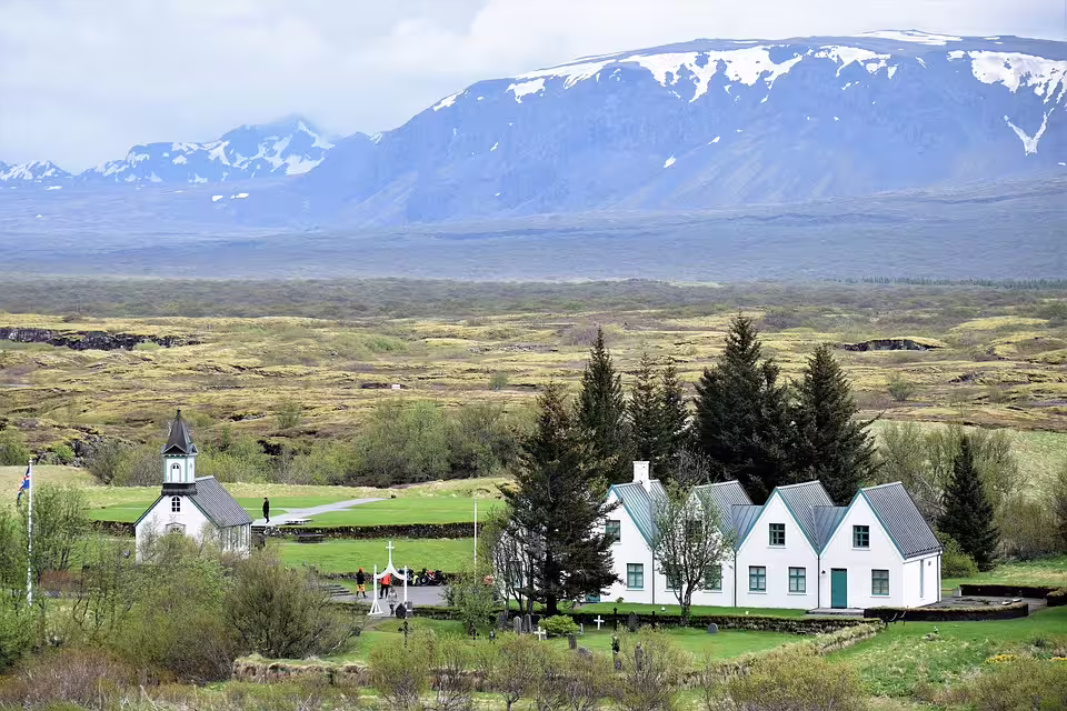 Þingvellir church and farmhouse with snow-capped mountains on Iceland's Golden Circle route