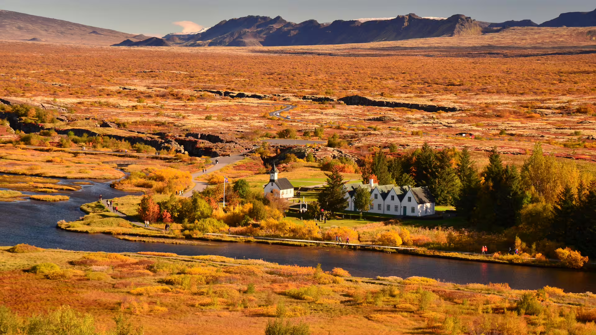 Aerial view of Þingvellir National Park in autumn with church, river, and volcanic landscape on Golden Circle Iceland