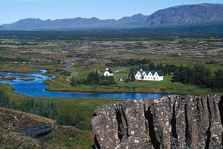 Þingvellir National Park with white church, river and volcanic cliffs on Iceland's Golden Circle route