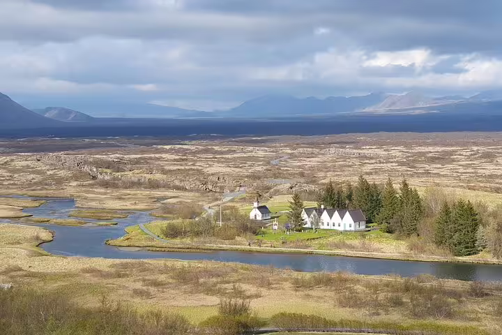 Aerial view of Þingvellir National Park with white church, river, and volcanic landscape on Golden Circle Iceland