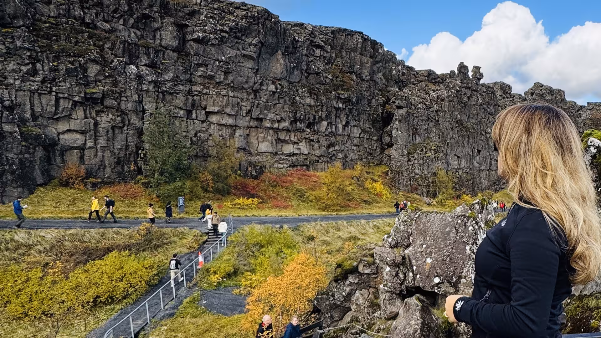 Tourists exploring the rugged landscapes of Thingvellir National Park on the Golden Circle Tour.