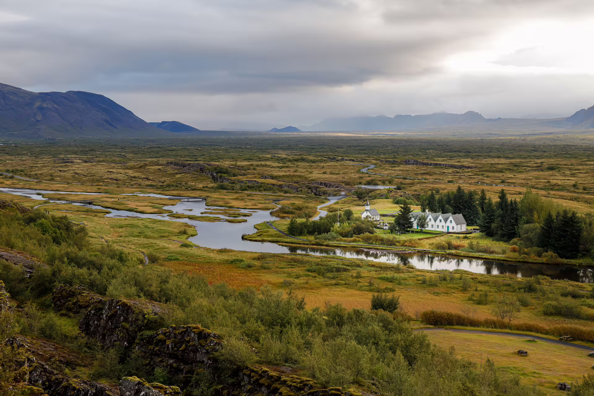 Aerial view of Þingvellir National Park Iceland with church, winding river, and volcanic landscape
