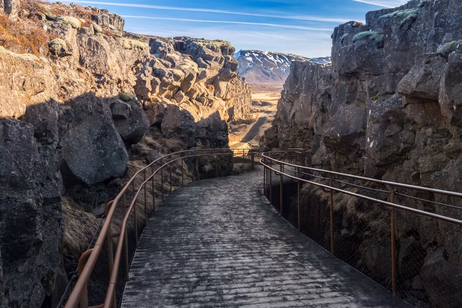 Scenic pathway through rocky cliffs in Thingvellir National Park on the Beautiful South with Blue Lagoon tour.