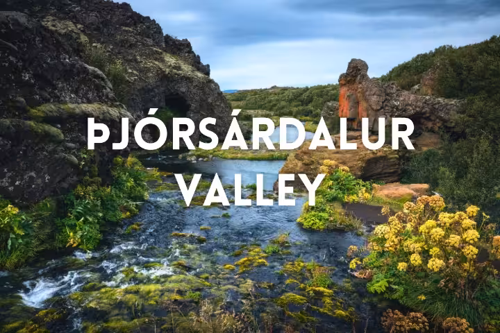 River flowing through Þjórsárdalur Valley with volcanic cliffs, lush greenery, on a private Iceland tour