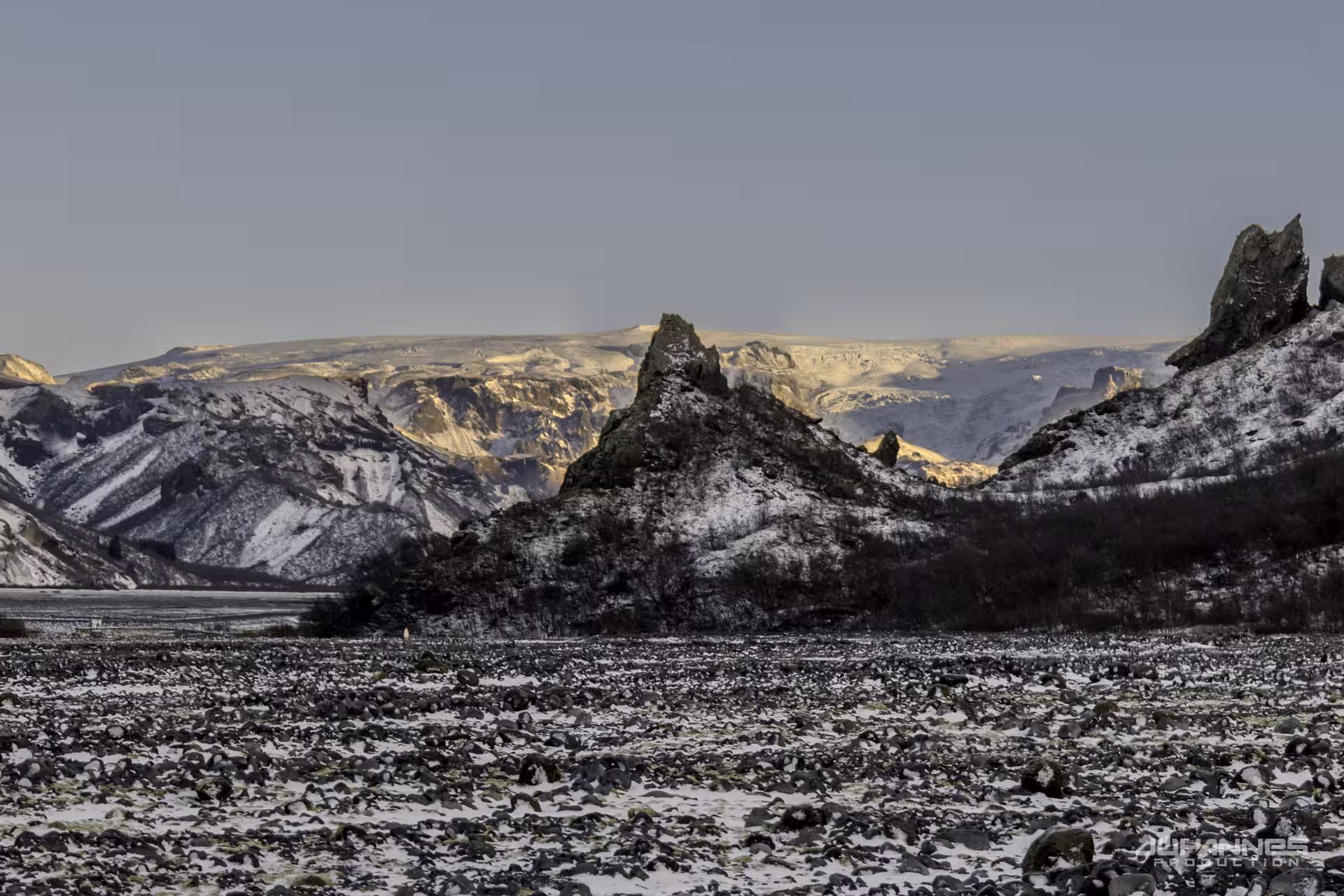Snow-dusted jagged volcanic peaks in Thorsmork Highland valley with glacier backdrop, Iceland