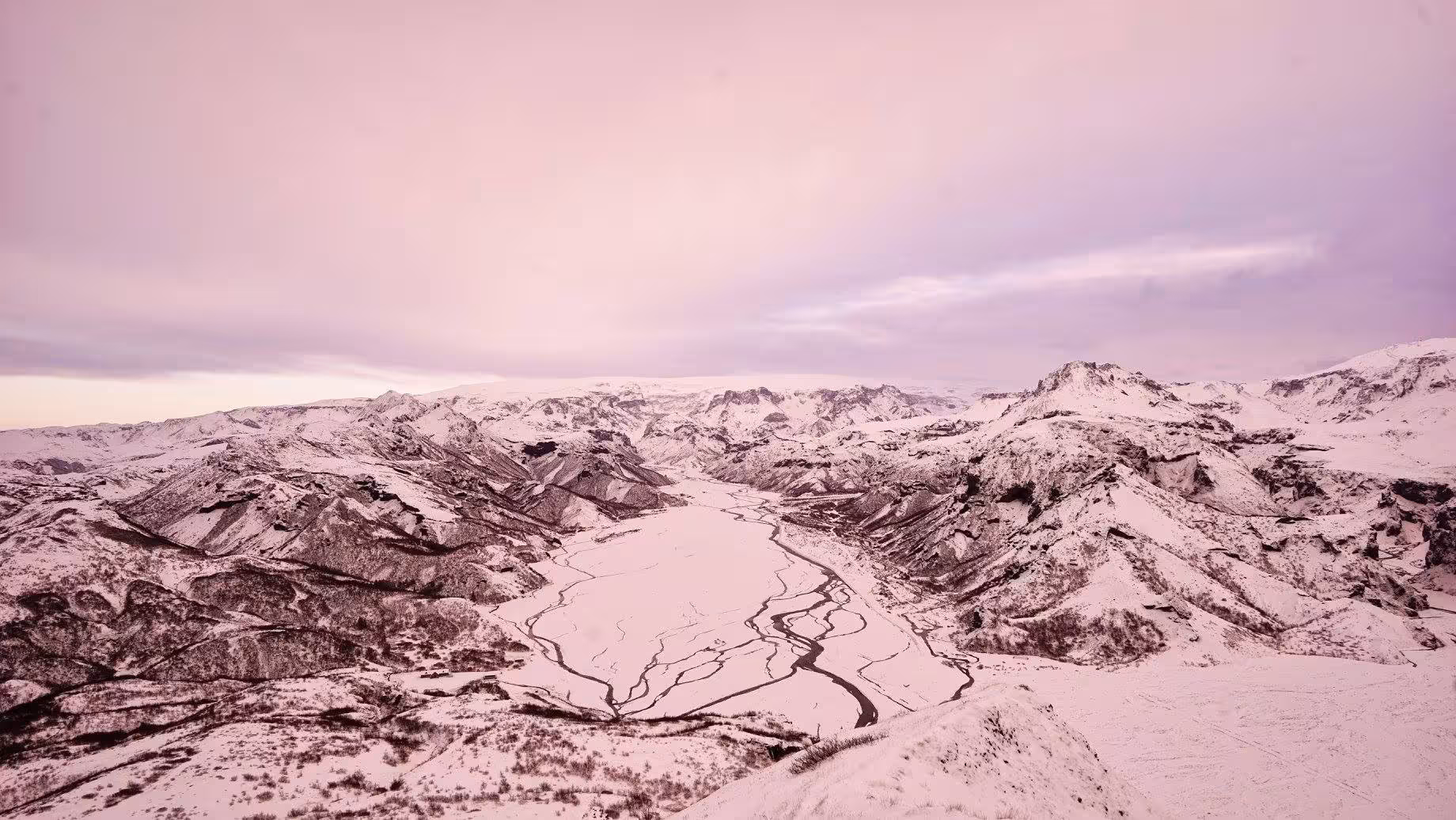 Rainbow over Thorsmork braided glacial river valley surrounded by green volcanic mountains in Iceland