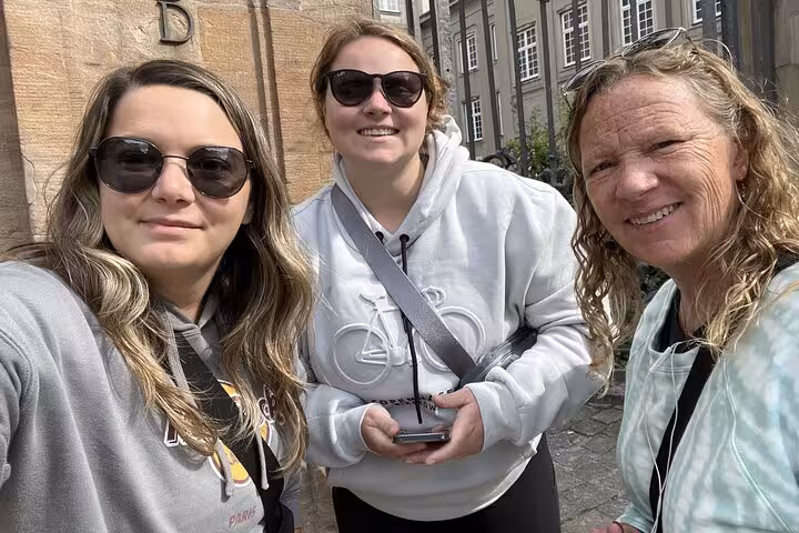 Three smiling women on a self-guided walking tour in Copenhagen city center