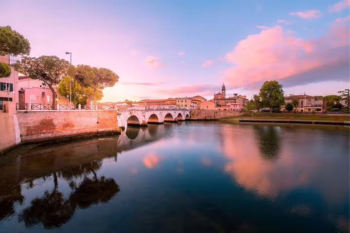 Tiberius Bridge over the Marecchia River at sunset in Rimini, highlight on a self-guided scavenger hunt tour