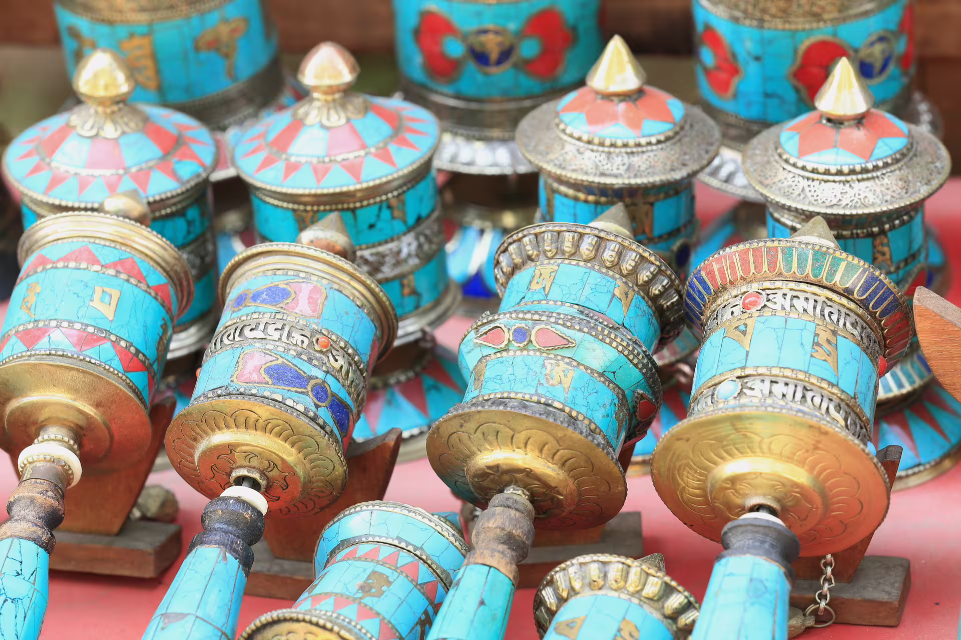 Colorful Tibetan prayer wheels with intricate designs in Kathmandu, showcasing rich cultural heritage.