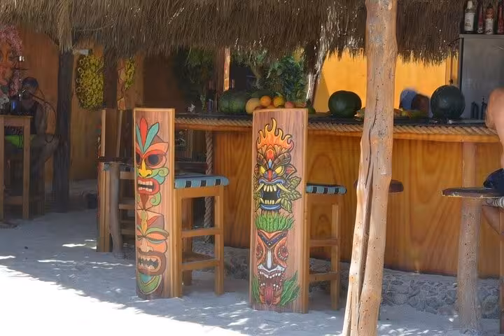 Tiki-style beach bar on Hula Hula Island with thatched roof and tropical decor, part of lunch and water sports