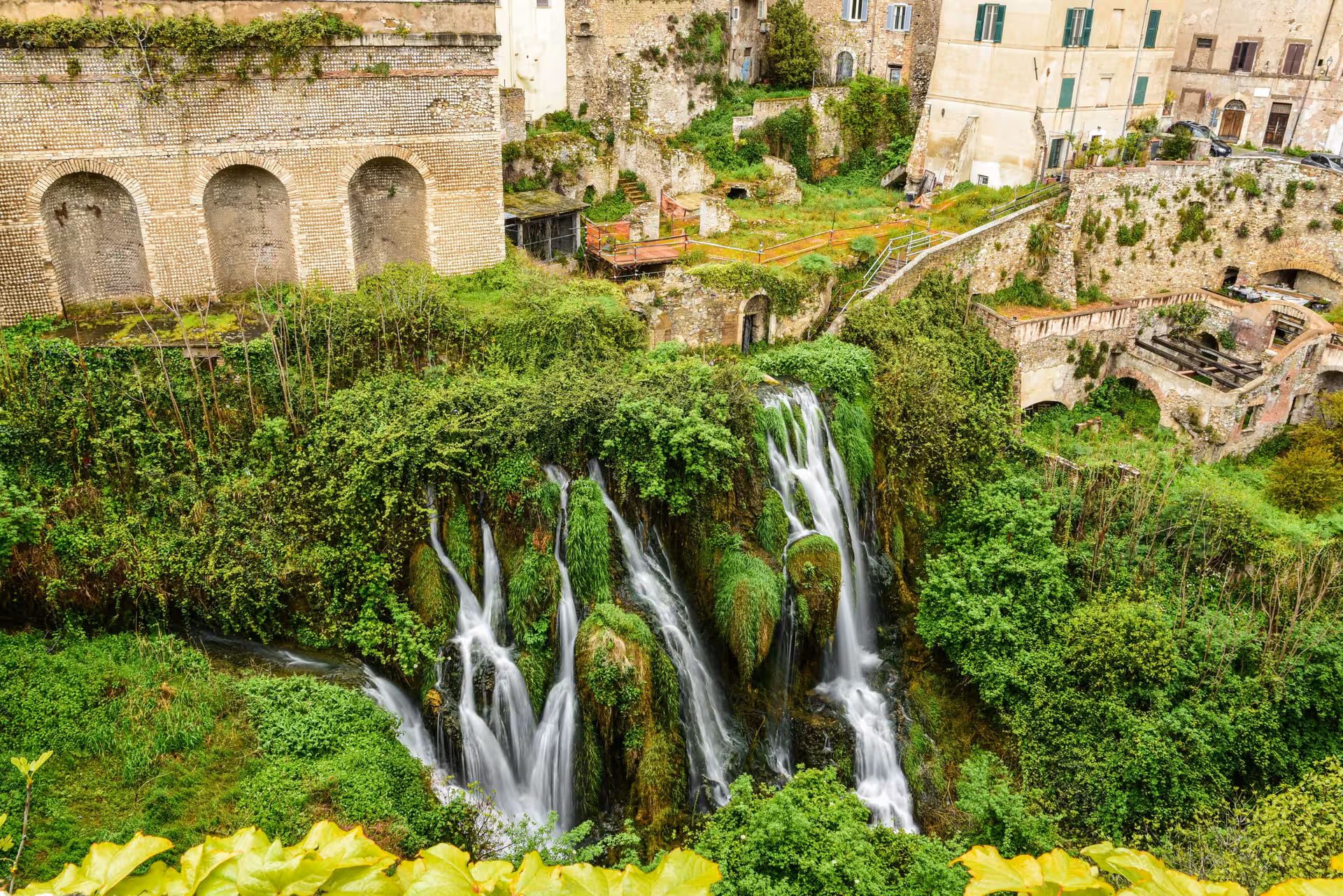 Lush greenery and cascading waterfall at a historic site in Tivoli, featured on the Fiat 500 vintage tour.