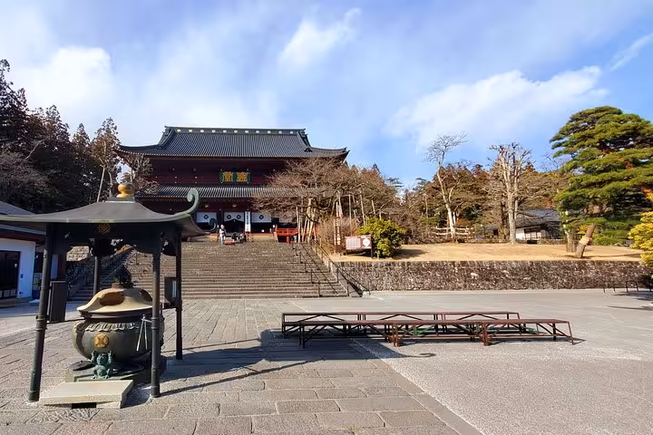 Historic entrance to a traditional temple surrounded by nature on a Tokyo to Nikko private guided tour.