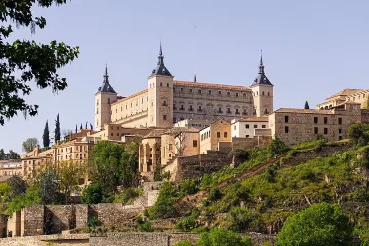 Alcázar of Toledo fortress on hilltop with medieval stone buildings and city views, Spain