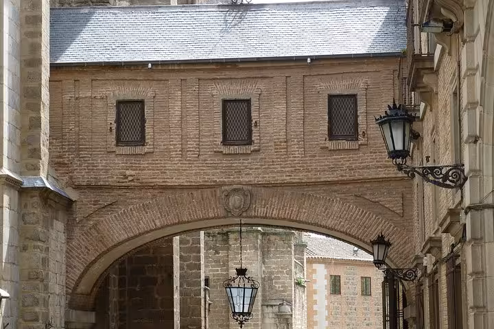 Charming brick archway in Toledo's old town, featuring historic architecture on a Granada, Toledo & Madrid tour.