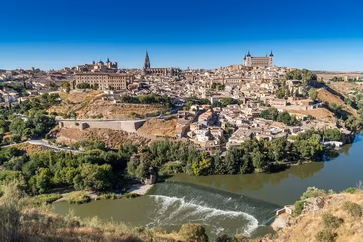 Stunning panoramic view of Toledo's historic architecture and scenic river, a highlight of the Toledo and Segovia day trip from Madrid.