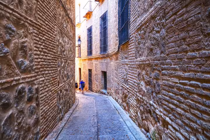 Picturesque winding alley in Toledo captures the medieval charm on a day trip from Madrid.