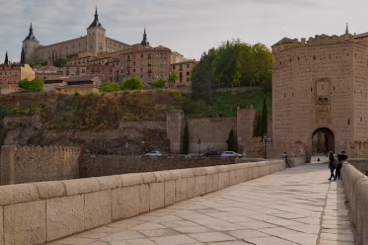 Puente de Alcántara leading to Toledo old town, key stop on a Toledo private minivan tour from Madrid