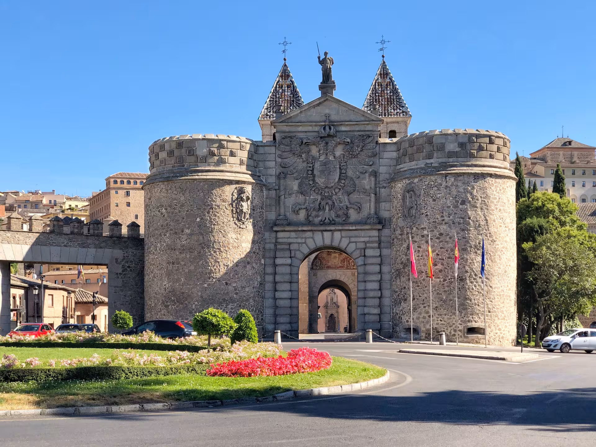 Historic Puerta de Bisagra gate in Toledo, showcasing medieval architecture and iconic stone towers.