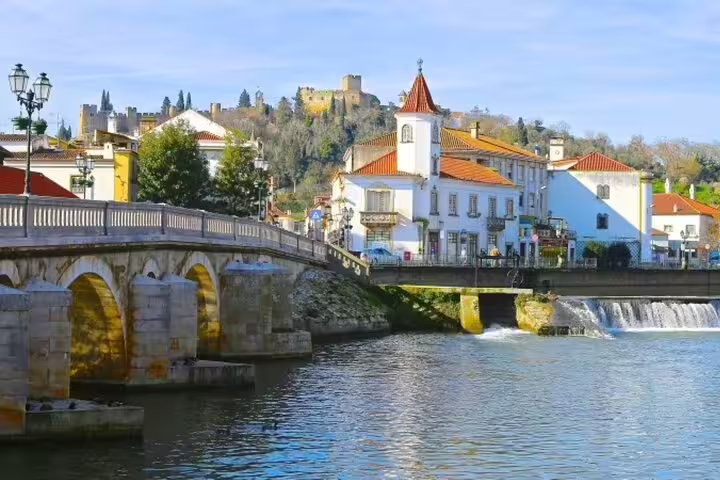 Scenic view of Tomar's historic architecture and riverside, perfect for a private full-day tour from Lisbon to Tomar and Coimbra.