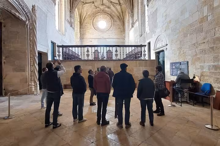 Visitors admire intricate architecture inside the Convent of Christ, a highlight of the Tomar private walking tour.
