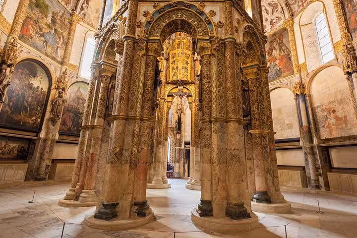 The ornate pillars and frescoes inside the Convent of Christ highlight its rich historical and architectural significance.
