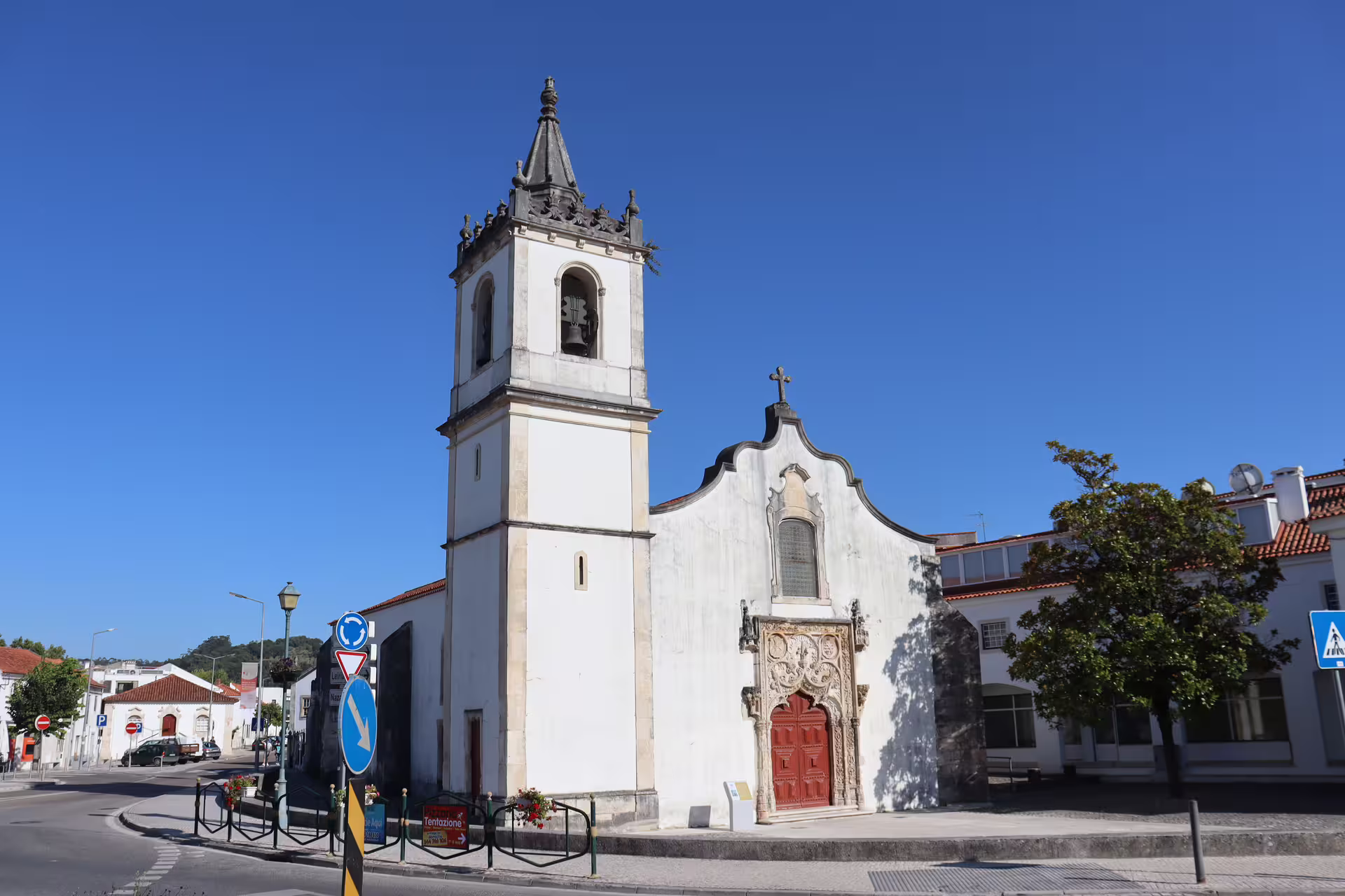 Historic church facade in Tomar, Portugal, showcasing intricate architecture on a sunny day, part of a private tour itinerary.