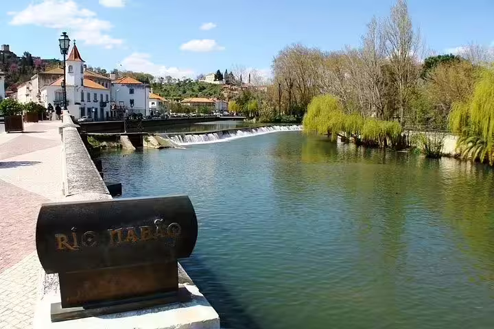 Scenic view of Nabão River in Tomar with historic architecture, perfect for exploring Knights Templar history on a private tour.