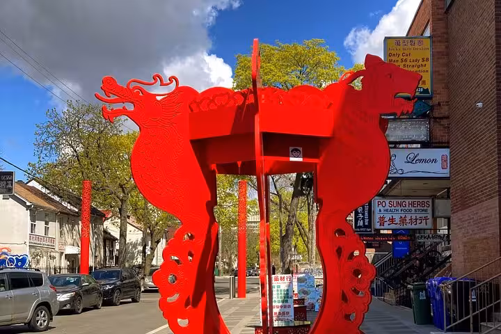 Vibrant red dragon sculpture in Toronto Chinatown featured on Reel Toronto GPS walking tour