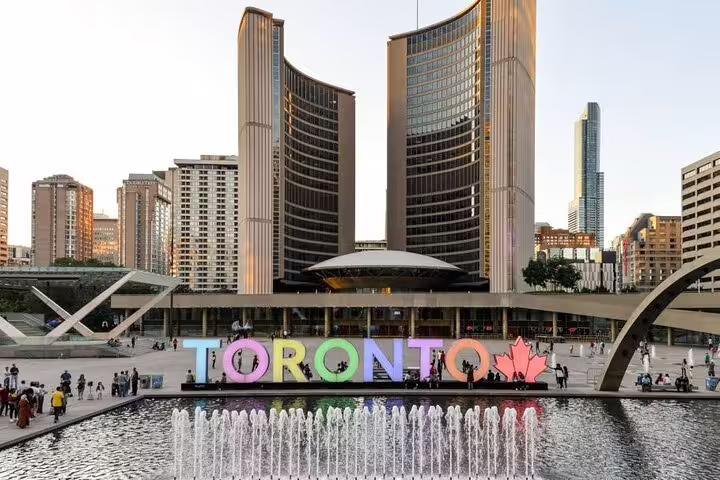 Toronto City Hall with colorful TORONTO sign and fountain at Nathan Phillips Square