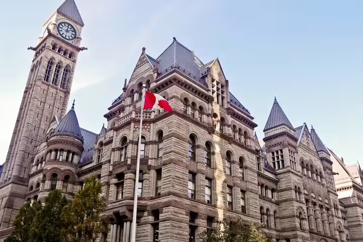 Toronto Old City Hall historic stone building with clock tower and Canadian flag