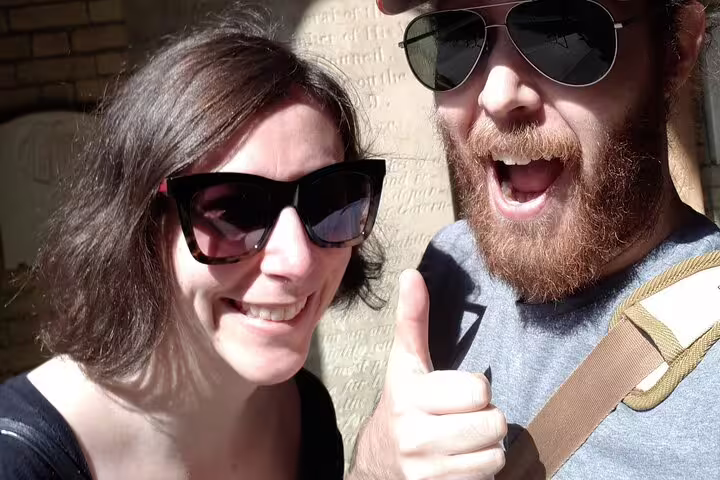 Smiling couple with sunglasses giving thumbs up on Toronto Old Town self-guided walking tour