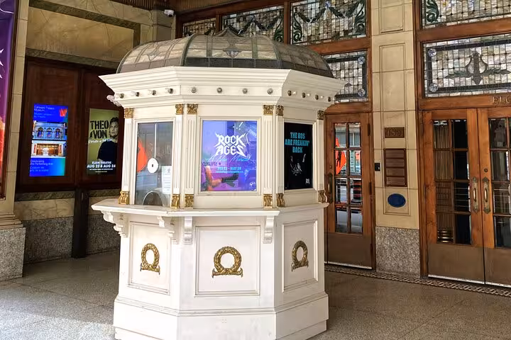 Historic Toronto theatre lobby kiosk with Rock of Ages display on self-guided smartphone tour