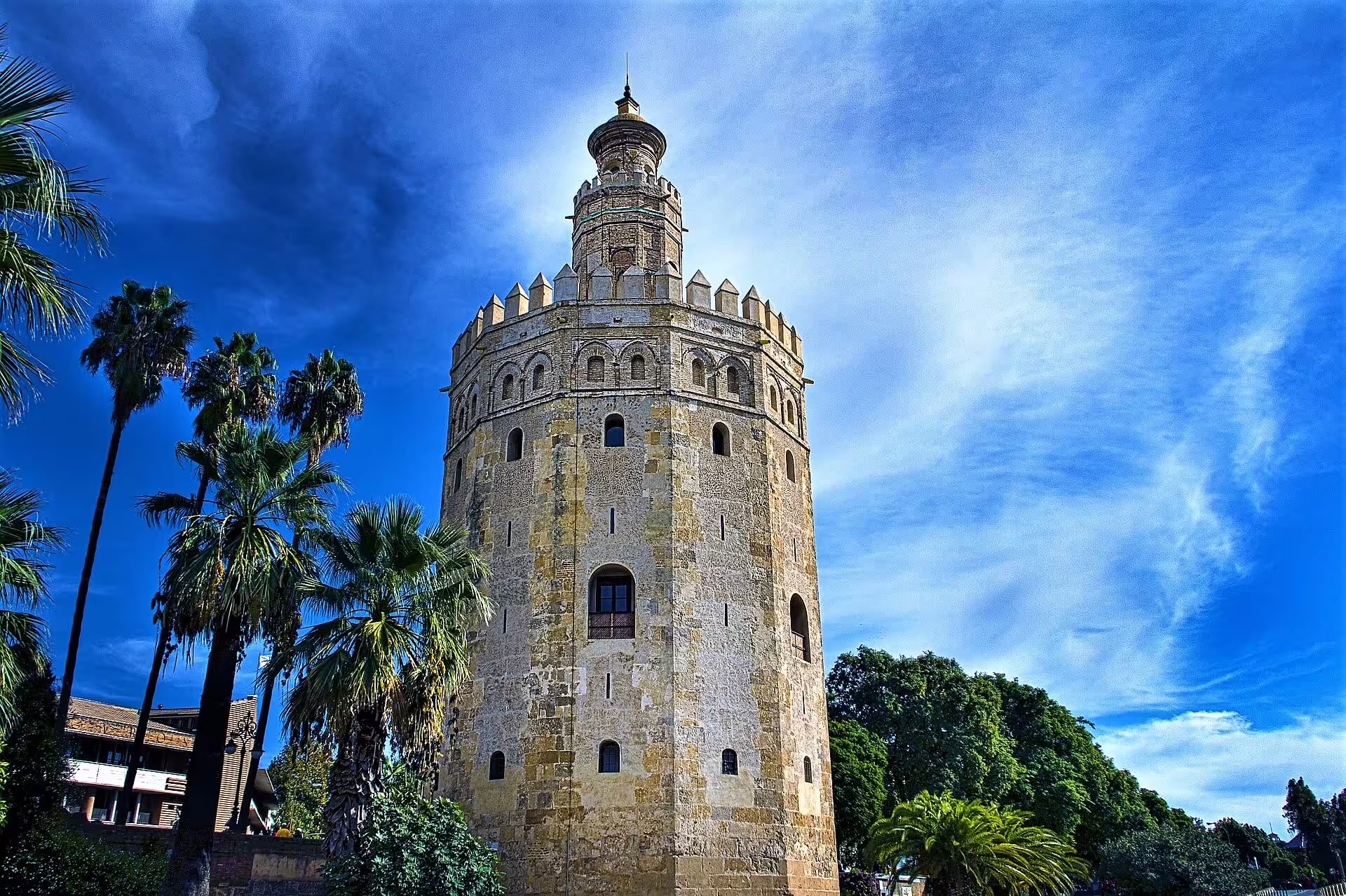 Torre del Oro in Seville under blue sky, landmark on Seville group trip with Costa del Sol pick-up